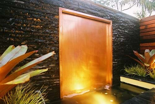 Copper water wall with splitstone surround
