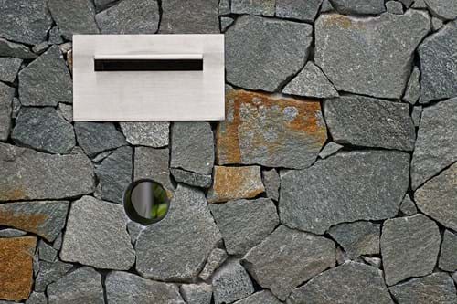 Porphyry stone clad wall with letterbox